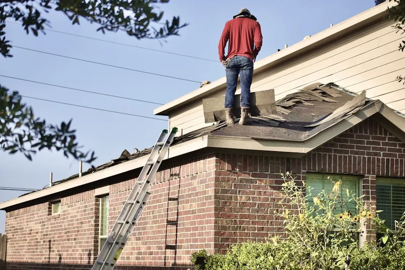 Professional roofer working on a residential roof in Hampton Golf Village